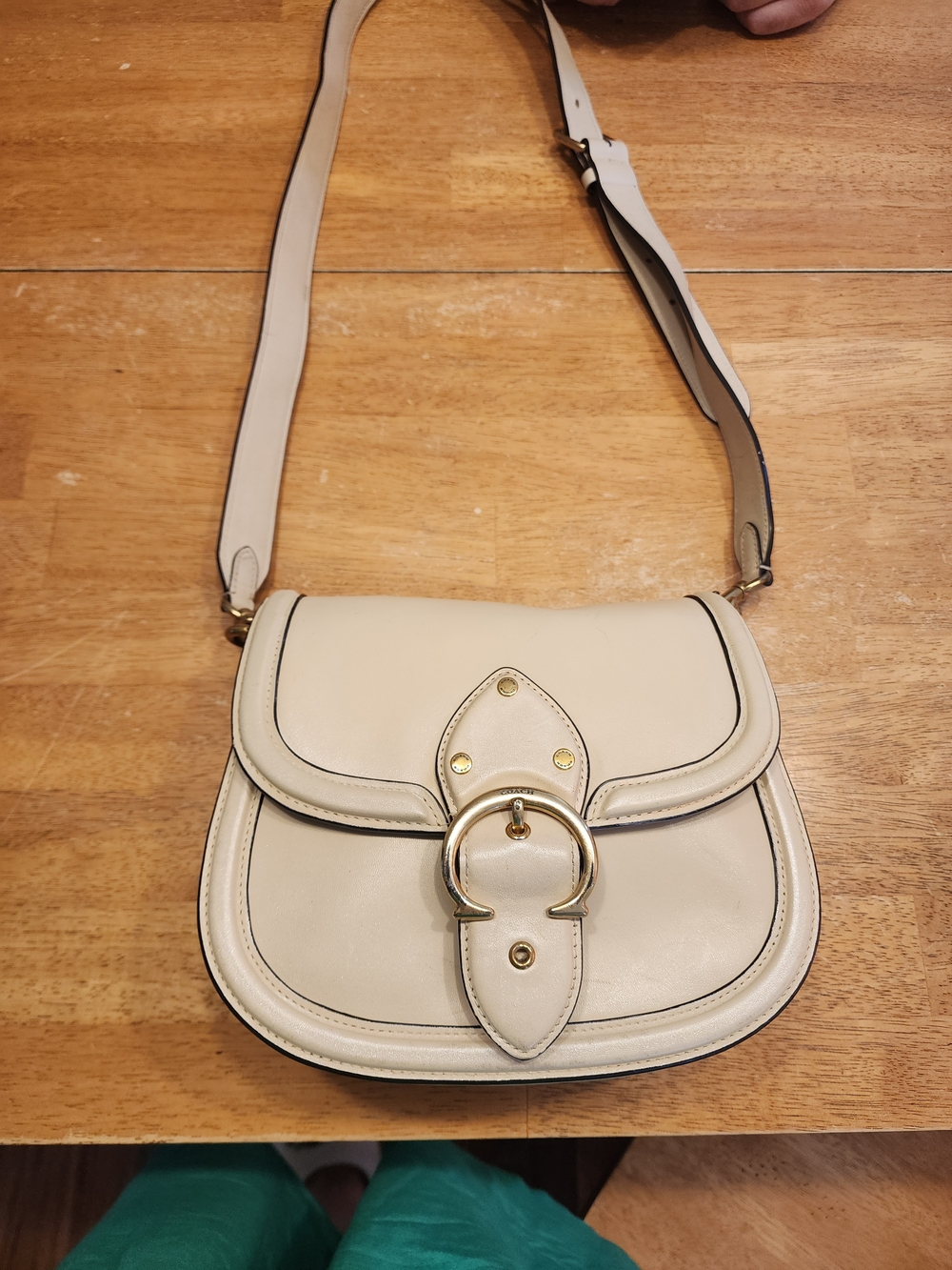 2021 Ivory Coach Beat saddle bag is crafted from glovetanned leather and brass
